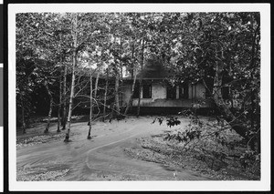 A vacation home showing water flumes that are evidence of heavy rains, ca.1930