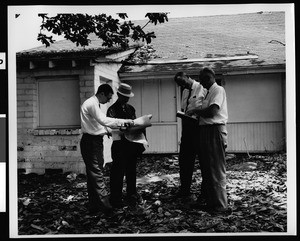 Four men assessing the Evertsen Adobe in San Gabriel before it was to be destroyed, 1960