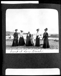 Group portrait of people on the sand in Long Beach, ca.1890