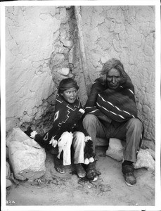 An old Navajo brave and his nephew, both huddled in their blankets, ca.1901