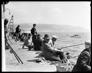 Fishermen on the edge of the pier in Redondo Beach, 1937