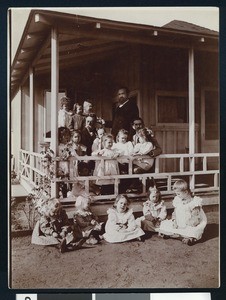 Young girls sitting on a porch with three men at the Theosophical Institute in Point Loma, ca.1902