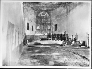 Interior of the old church during early morning mass at the Acoma Pueblo, New Mexico, 1886