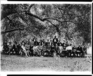 Members of the Sunset Club posing for a picture beneath the branch of a massive live oak tree, ca.1910