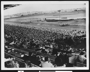 A racetrack, from the spectators' view, possibly at Hollywood Park Racetrack, ca.1930