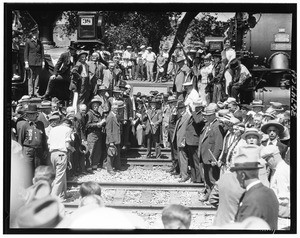 Wedding of the rails", showing a man with a large hammer at center, 1926