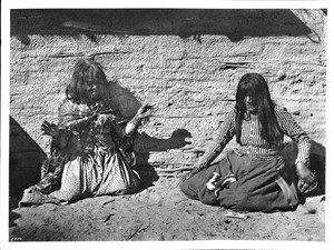 Two Mojave Indian woman playing a game (fortune-telling with bones?), ca.1900