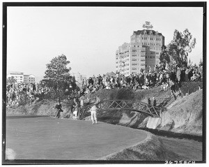 Bridge leading to an elevated green during a golf tournament at the Wilshire Country Club, 1931