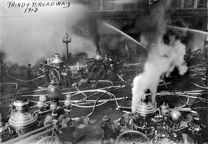 Los Angeles firefighters tending their water pumps during a fire at Third Street and Broadway, ca.1913