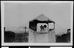 Department of Public Works surveyor at work in a small tent