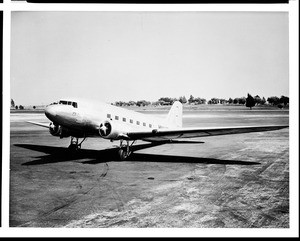 Douglas DC-3 airliner built in Los Angeles County sitting on a runway, 1940-1950