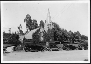 Exterior view of the Church in Forest Lawn Cemetery with several cars parked in front of it, ca.1915-1930