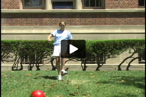 A young female soccer player passing inside the left foot