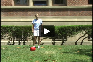 A young female soccer player passing inside the right foot