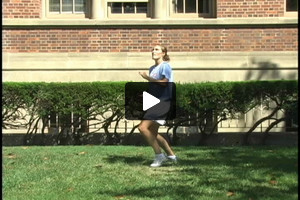 A young female soccer player heading up