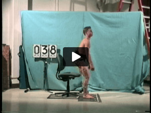 A young male diver performing a sit to stand from a high chair