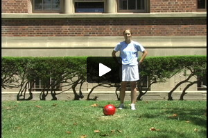 A young female soccer player passing outside the right foot