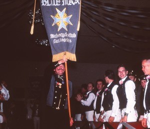 Hal Hegge carrying Blue Max Motorcycle Club Los Angeles banner