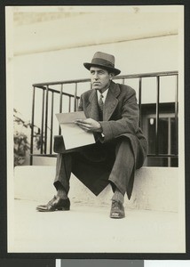 University of Southern California assistant football coach Aubrey Devine, seated outdoors, location unknown, 1931