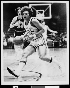 Mark Wulfemeyer, a USC guard, running forward with a basketball, 1975