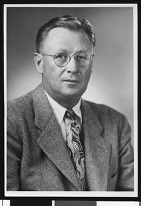 University of Southern California head football coach Jeff Cravath in a studio shot, flecked suit coat and flowered tie. Los Angeles, 1949