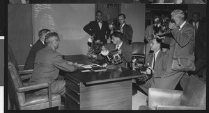 Press conference for new University of Southern California head football coach Jess Hill, with many photographers taking pictures, January 1951