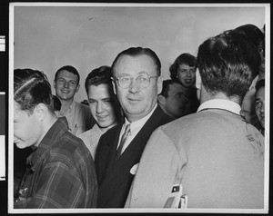 University of Southern California football coach Jeff Cravath surrounded by students at a student rally, USC campus, 1950