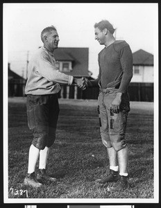 University of Southern California football coach Howard Jones shaking hands with quarterback Morley Drury, Bovard Field, USC campus, 1927