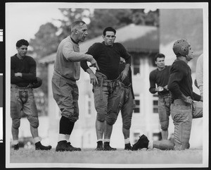 University of Southern California football coach Howard Jones at football practice, coaching the varsity team. Bovard Field, mid-1930s