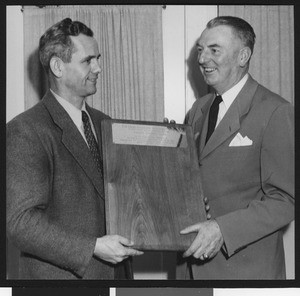 Jess Hill and University of Southern California sports coach Sam Barry (right) holding the new Ernie Holbook Award in 1947, USC campus