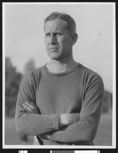 University of Southern California football coach Howard Jones, in darker sweatshirt with arms folded, torso up, mid 1920s