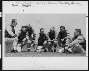 University of Southern California football coaching staff wearing letter jackets, 1949, Bovard Field, USC campus