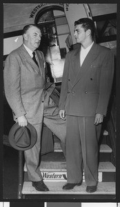 University of Southern California baseball coach Sam Barry with Wally Hood in front of a Western Airline plane at Los Angeles Airport, 1948