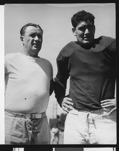 University of Southern California football coach Jeff Cravath with USC football player John Ferraro on Bovard Field, USC campus, 1946