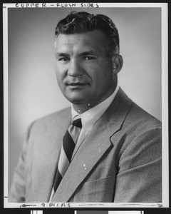 University of Southern California assistant football coach Ray George, studio shot, diagonally striped tie, grey jacket, 1949