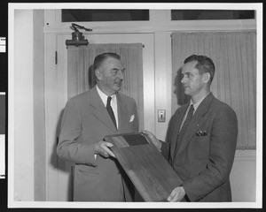 University of Southern California sports coach Sam Barry (left) and Jess Hill holding the new Ernie Holbook Award in 1947, USC campus