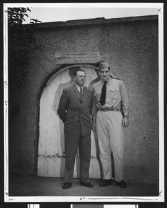 University of Southern California football coach Jeff Cravath with USC football player John Ferraro in front of Bovard Field Gate, USC campus, 1944