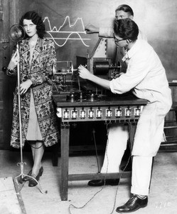 Two men students and a woman student experimenting with a radio microphone, ca. 1928