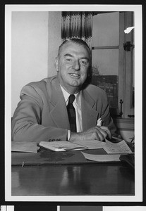 University of Southern California assistant football coach Sam Barry, in an office, wearing a suit and striped dark tie, USC campus, 1948