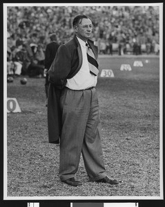 University of Southern California football coach Jeff Cravath on the sidelines at the Los Angeles Coliseum, 10-yard markers behind him, circa 1947-1949