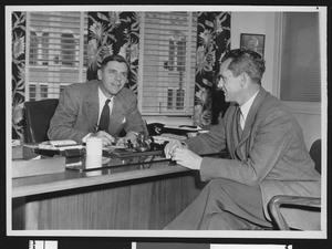 alumni review editor Arnold Eddy (left) and University of Southern California coach Jess Hill, USC campus, 1947