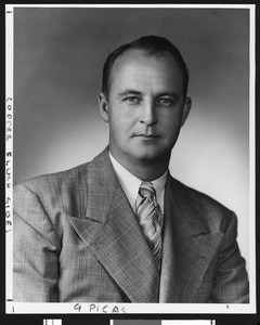 University of Southern California assistant football coach Walt Hargesheimer, studio shot in swatched tie and tweed coat, Los Angeles, 1949