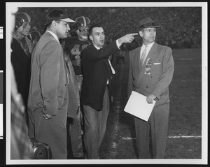 University of Southern California football coaches Hill, Broadbent, and Muha coaching the Rose Bowl game, USC vs. Wisconsin, 1953