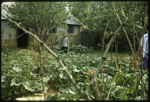 A Villager in front of Her House