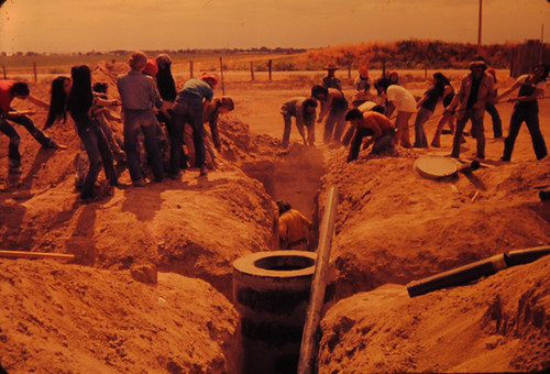 Volunteers digging drainage ditch at Agbayani Village