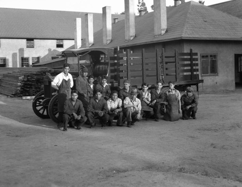 Students and faculty in front of truck