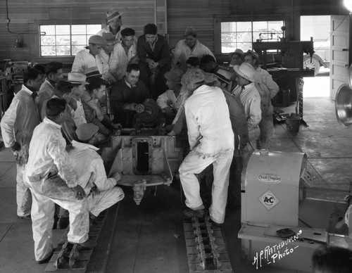 Students learn to repair an engine in shop class