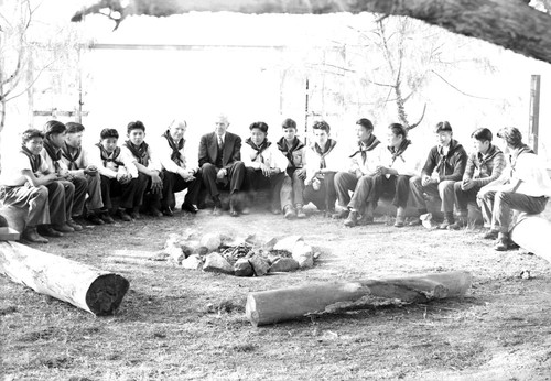 Boy Scout troop sitting around campfire