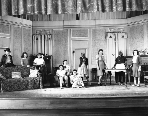 Students in costumes performing on stage