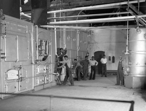 Students examining parts of boiler